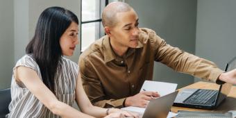 Two people looking at something on a computer screen