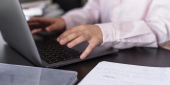 girl using laptop keyboard